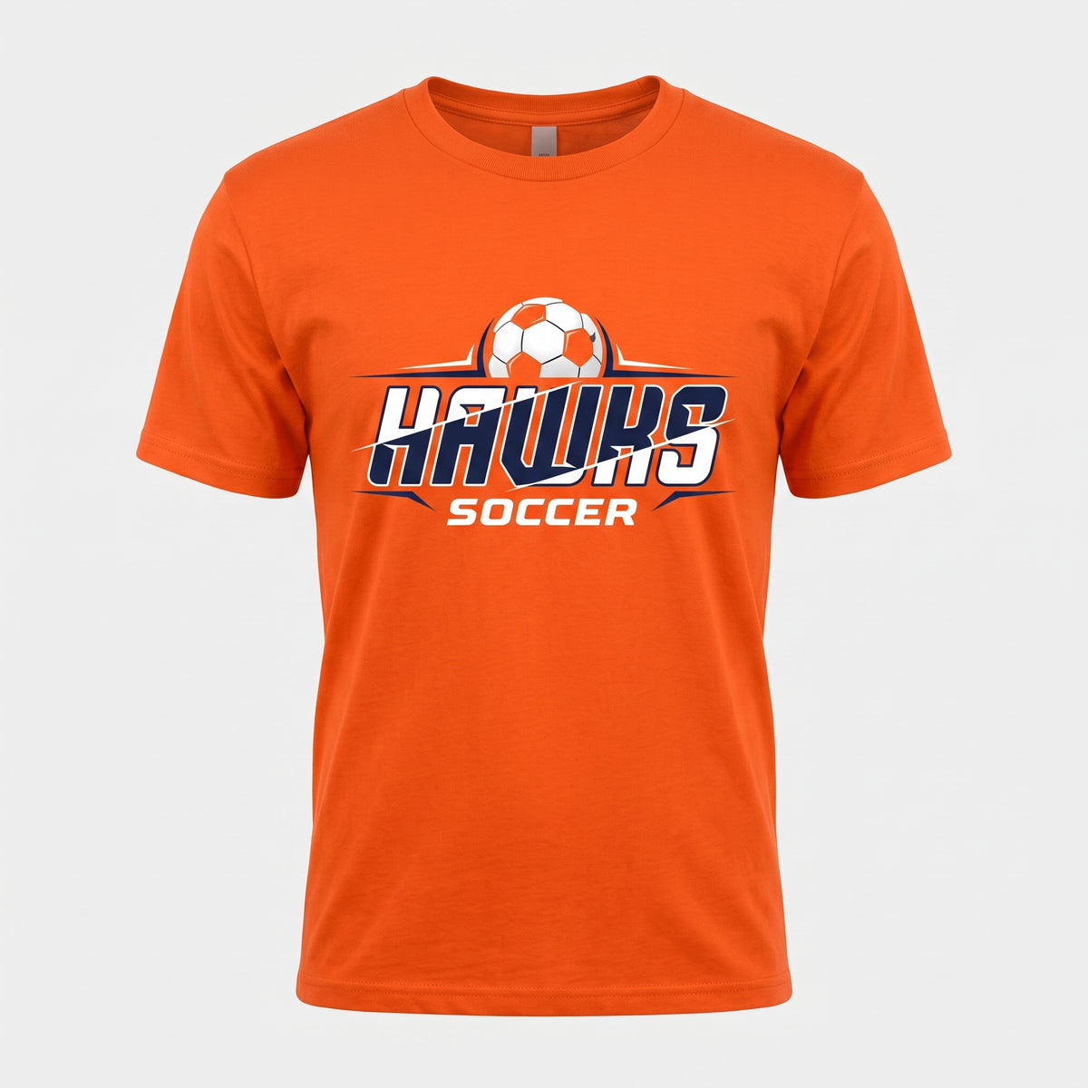 An orange short-sleeve crewneck t-shirt featuring a 'Hawks Soccer' graphic on the chest with a soccer ball illustration, shown against a light gray background.
