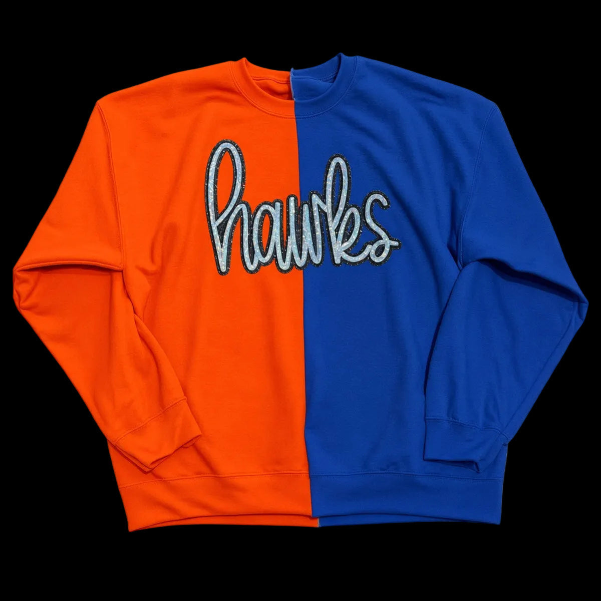 A long-sleeve crewneck sweatshirt with a vertical split design, featuring a bright orange left side and a royal blue right side. The word 'hawks' is printed across the center in a stylized white cursive font with a light blue outline.