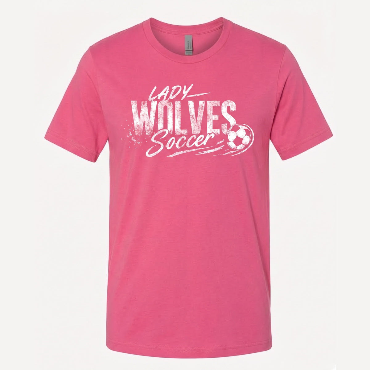 A pink short-sleeve crewneck t-shirt featuring a white distressed graphic on the front that reads 'LADY WOLVES Soccer' alongside a soccer ball illustration, displayed against a light off-white background.
